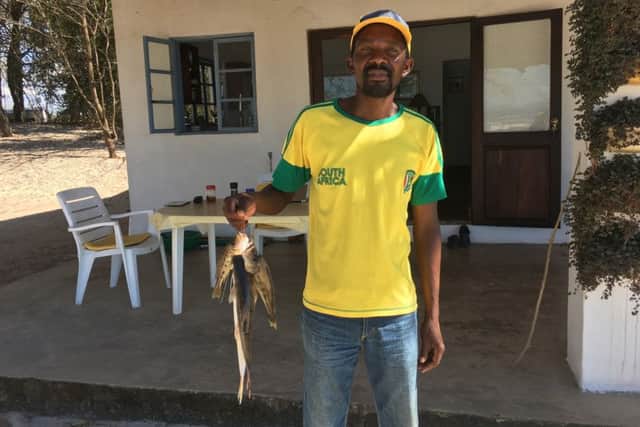 Chimwaza Phiri, with freshly caught kampango, a catfish, from Lake Malawi, says life is better than before, but still if our harvest fails, then we dont eat