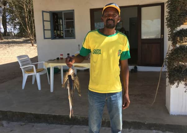 Chimwaza Phiri, with freshly caught kampango, a catfish, from Lake Malawi, says life is better than before, but still if our harvest fails, then we dont eat