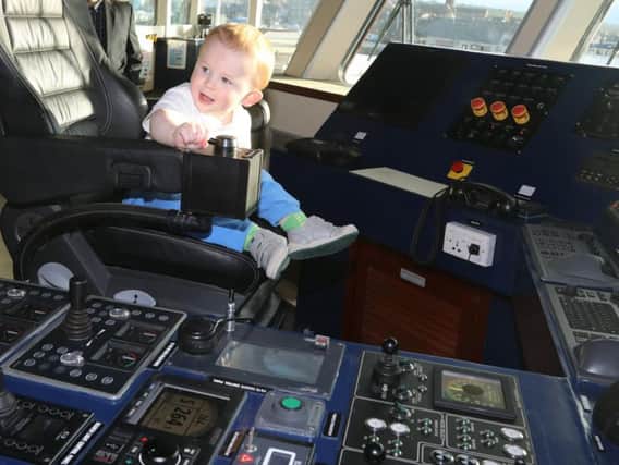 MV Alfred owner Andrew Banks' grandson Eddy, one, in the captain's chair of the brand new vessel. Picture: Orkney Photographic