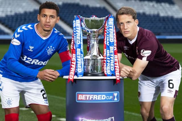 Rangers captain James Tavernier and Hearts counterpart Christophe Berra with the Betfred Cup. Picture: Ross Parker/SNS