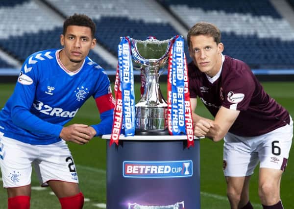 Rangers captain James Tavernier and Hearts counterpart Christophe Berra with the Betfred Cup. Picture: Ross Parker/SNS