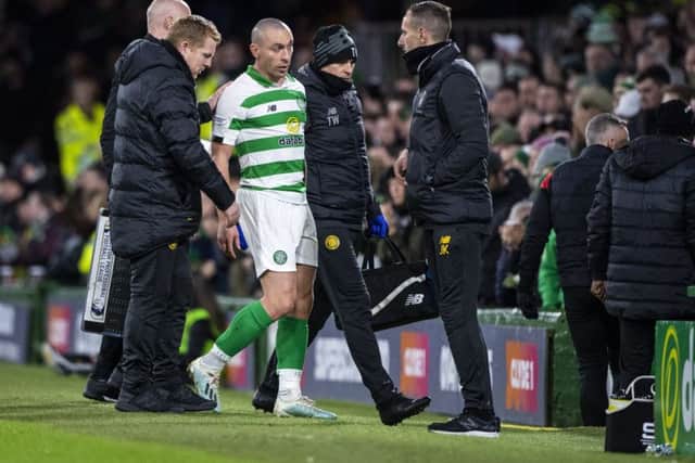 Celtic captain Scott Brown leaves the field after picking up a knock against St Mirren on Wednesday and remains doubtful today. Picture: SNS.