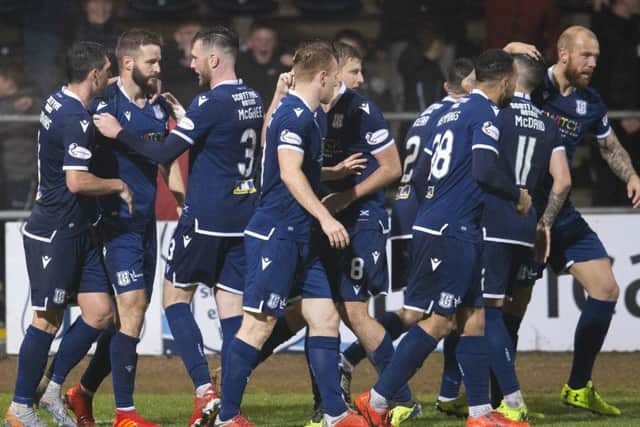 Jamie Ness, left, is congratulated by his team-mates after putting Dundee 2-1 ahead against Morton. Picture: Bruce White/SNS