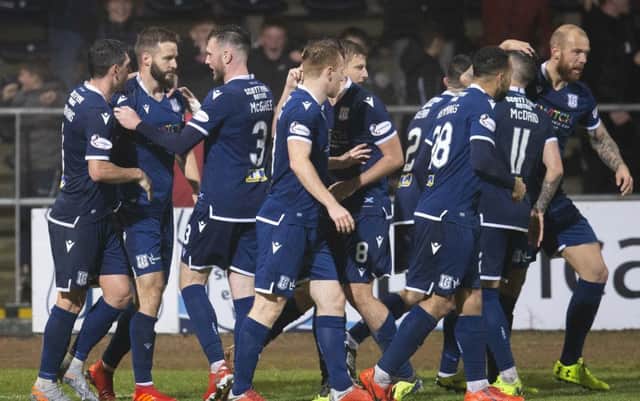 Jamie Ness, left, is congratulated by his team-mates after putting Dundee 2-1 ahead against Morton. Picture: Bruce White/SNS