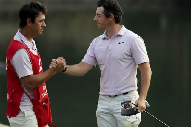 Rory McIlroy shakes hands with caddie Harry Styles after moving into the lead after the third round of the WGC-HSBC Champions in Shanghai. Picture: AP