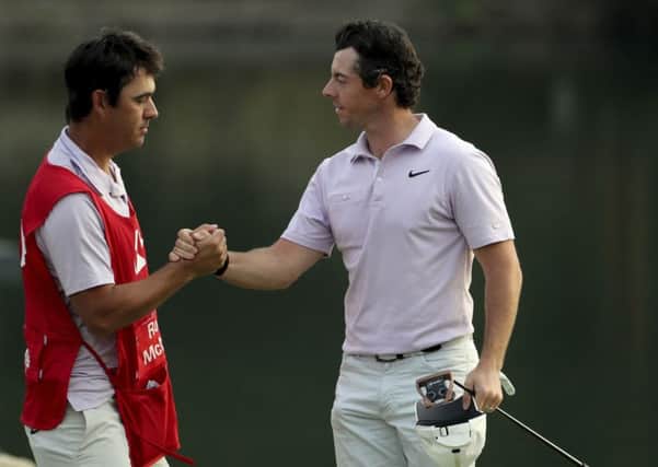 Rory McIlroy shakes hands with caddie Harry Styles after moving into the lead after the third round of the WGC-HSBC Champions in Shanghai. Picture: AP