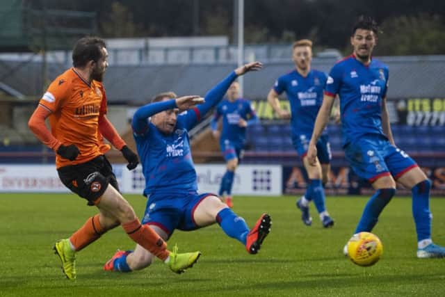 Uniteds Paul McMullan sees his shot deflected into the goal off Shaun Rooney to make it 1-0. Photograph: Bill Murray/SNS