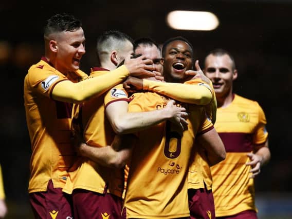 Allan Campbell is mobbed by team-mates after netting a late winner for Motherwell. Picture: SNS