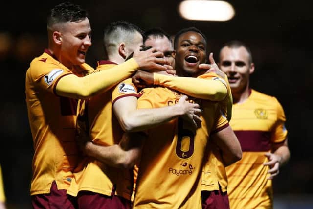 Allan Campbell is mobbed by team-mates after netting a late winner for Motherwell. Picture: SNS