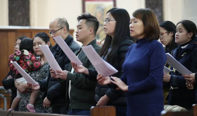 Members of the congregation at the mass prayer and vigil for the 39 victims found dead inside the back of a truck in Grays, Essex, at The Holy Name and Our Lady of the Sacred Heart Church, London's Vietnamese church, in east London. PA Photo. Picture date: Saturday November 2, 2019. See PA story POLICE Container. Photo credit should read: Yui Mok/PA Wire