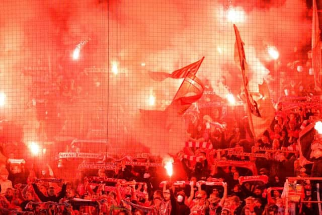 Union Berlin fans light flares and wave scarves during the derby with Hertha at the Stadion An der Alten Frsterei