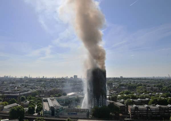 Smoke billows from a fire that has engulfed the 24-storey Grenfell Tower in west London. Picture: Victoria Jones/PA Wire