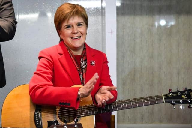The First Minister was on the campaign trail in Dalkeith on Tuesday where she joined folk musicians in a rendition of Monkees hit I'm a Believer. Picture: AFP/Getty Images