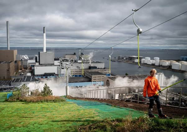 Taking the easy way up the artificial ski slope that sits on top of Copenhill, Copenhagen's innovative new waste-to-energy plant. PIC: Niels Christian Vilmann / Ritzau Scanpix / AFP