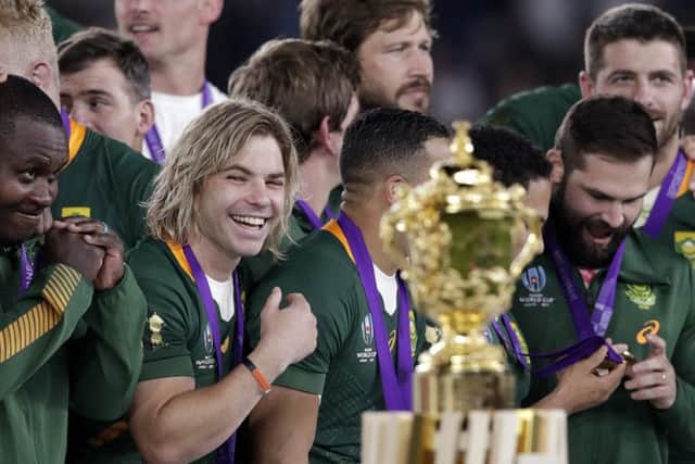 South Africa's Faf de Klerk, fourth left, smiles just before his team receives the Webb Ellis Cup. Picture: Aaron Favila/AP