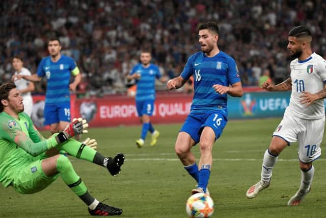 Vasilios Barkas in action (left) for Greece against Italy