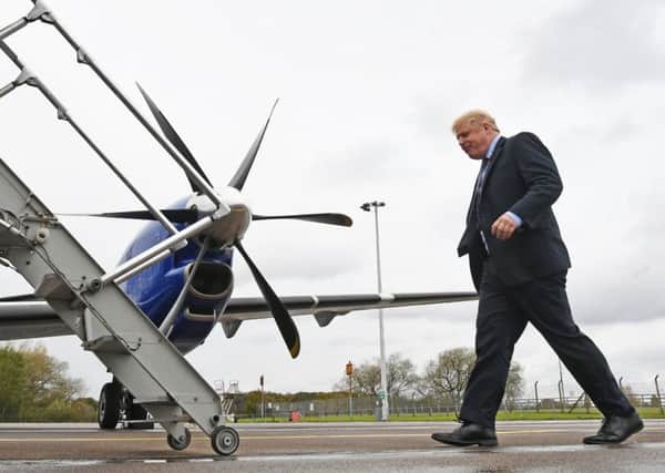 Boris Johnson boards his plane bound for Scotland. Picture: Stefan Rousseau/PA