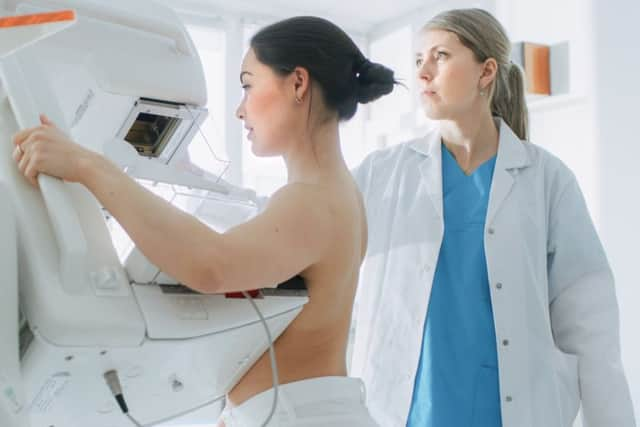 A woman undergoes a screening test for breast cancer