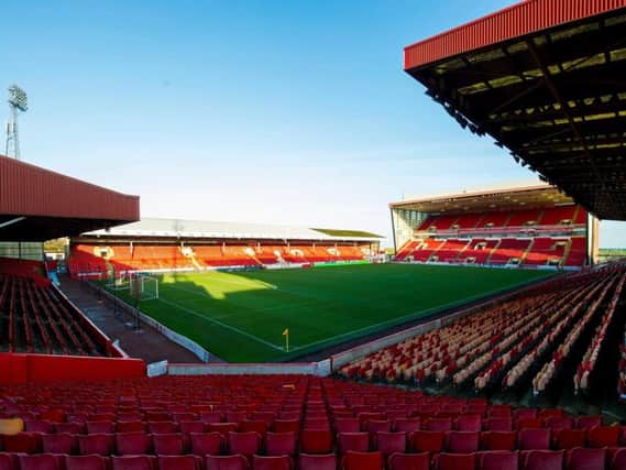 A police investigation is underway after an 18-year-old was subjected to racist abuse and assaulted  near Pittodrie Stadium in Aberdeen (pictured). PIC: AFC.