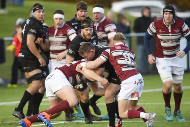 Russell Anderson of Southern Knights runs into
Watsonians' Roan Frostwick. Picture: Greg Macvean
