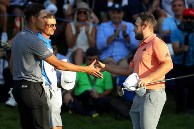 Matthias Schwab, left, congratulates winner Tyrrell Hatton after the six-man play-off was decided at the fourth extra hole. Picture: Getty Images