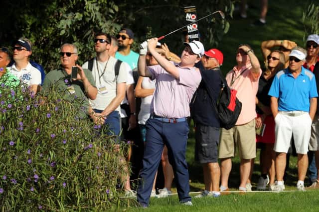 Bob MacIntyre plays his second shot on the thirteenth from behind a bush. Picture: Warren Little/Getty Images