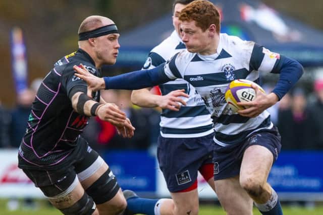 Robert Kay of Heriots hands off Ayrshire Bulls Graham Geldenhuys during the Edinburgh sides victory. Picture: SNS/SRU.