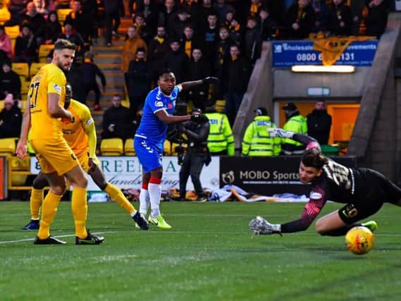Alfredo Morelos squeezes his low shot into the far corner to secure the points for Rangers. Picture: SNS