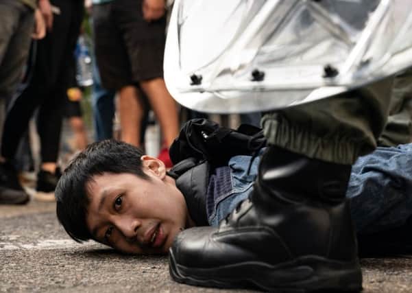 A pro-democracy protester is detained by riot police in Hong Kong (Picture: Anthony Kwan/Getty Images)