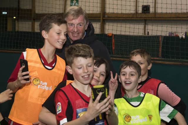 Youngsters take pictures with Kenny Dalglish when the McDonalds Fun Football ambassador paid a surprise visit to a coaching session at  Allander Leisure Centre in Bearsden.