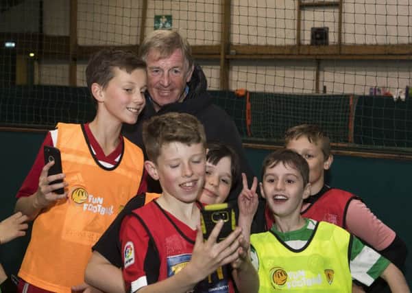 Youngsters take pictures with Kenny Dalglish when the McDonalds Fun Football ambassador paid a surprise visit to a coaching session at  Allander Leisure Centre in Bearsden.
