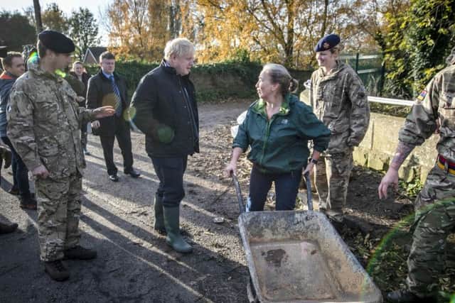 One frustrated woman, who was pushing around a wheelbarrow and assisting the troops, refused to speak to the Prime Minister.