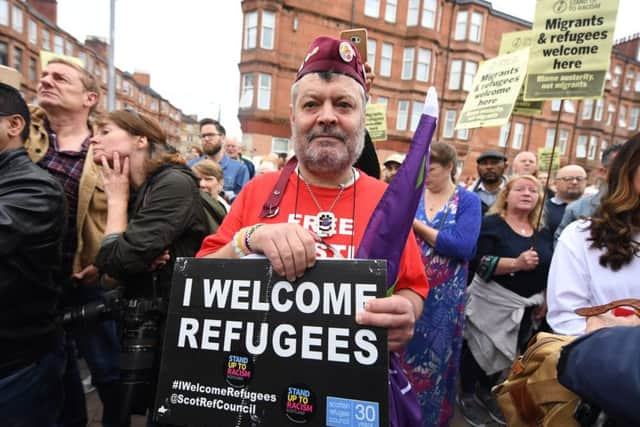 People in Glasgow protest against attempts to evict asylum seekers (Picture: John Devlin)