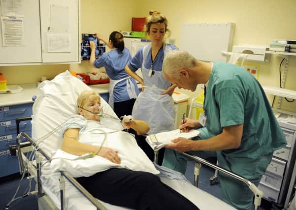 Consultant Simon Leigh-Smith at Edinburgh Royal Infirmary in the accident and emergeny (A&E) department with Maureen Hogg, who suffered a bad break in her elbow after a fall. Picture: Greg Macvean
