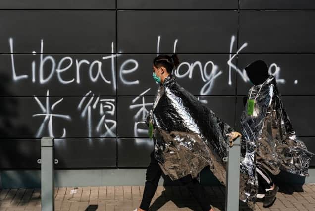 Unwell and injured protesters leave the Hong Kong Poytechnic University after clashes between pro-democracy campaigners and police (Picture: Anthony Kwan/Getty Images)