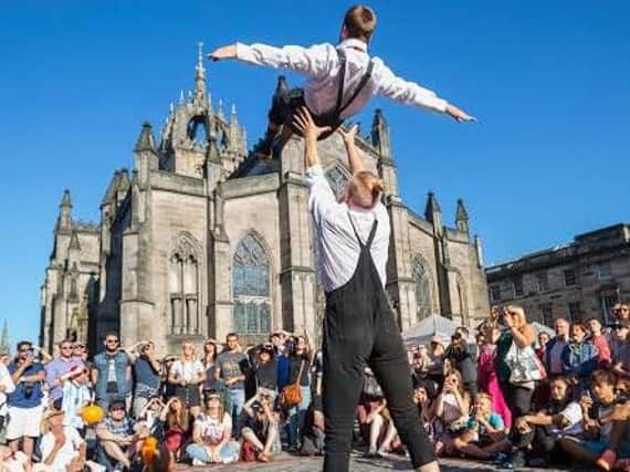 Some of the members from Australia's leading circus troupe 'Casus' celebrated the final week of the Edinburgh Fringe by performing excerpts from their acclaimed show DNA on top of the Royal Mile's 'Fringe' sign. Picture: Jane Barlow/PA