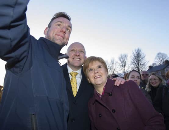 Nicola Sturgeon and SNP candidate Calum Kerr posing for a selfie in Hawick this week. Picture: Bill McBurnie