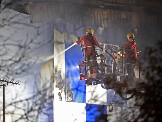 Fire fighters at the scene after a fire on the top floors of a building on Bradshawgate in Bolton. Picture: PA