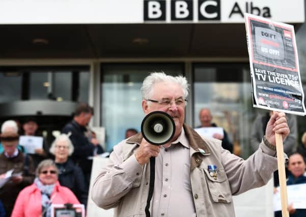 A licence fee protester outside the BBC at Pacific Quay