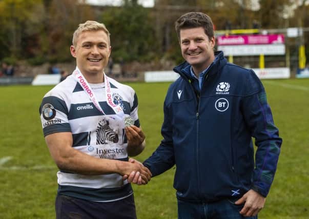 Iain Wilson receives his Man of the Match award from Scottish Rugbys chief operating officer Dom McKay.  following Heriots victory over Ayrshire Bulls last week. Photograph: Gary Hutchison/SNS/SRU.