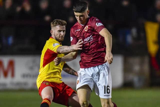 Partick Thistles Chris Slater, left, battles for the ball with Stenhousemuirs Conor McBride. Photograph: Rob Casey/SNS Group