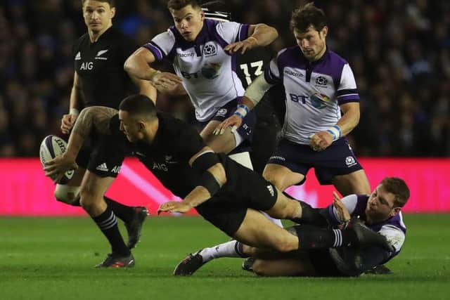 Finn Russell tackles Sonny Bill Williams during the last Autumn Test meeting between the two teams in November 2017