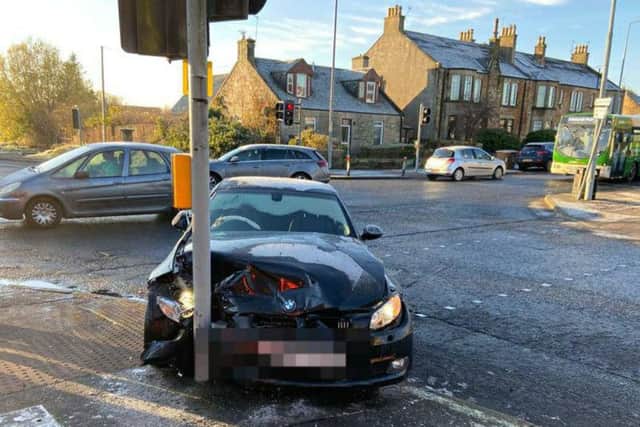 A man was charged with dangerous driving after a BMW crashed into traffic lights while its windscreen was frosted over.