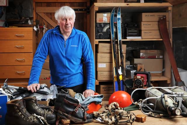 Mick Tighe pictured with some of the mountaineering memorabilia in his Scottish Mountain Heritage Collection, notably oxygen tanks used on the successful first ascent of Everest in 1953, far right. PIC: Jane Barlow