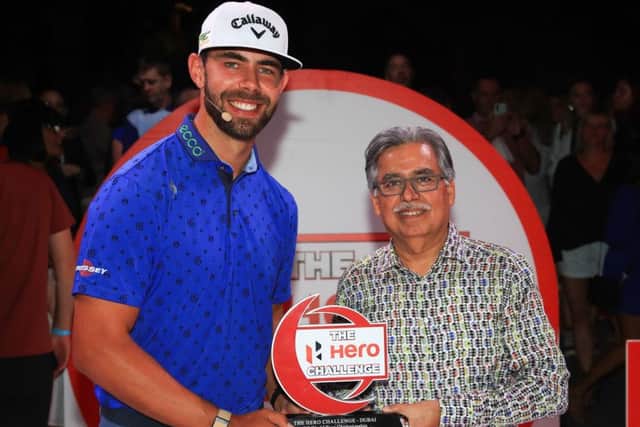 South African Erik Van Rooyen oreceives the trophy from Pawan Munjal, chairman of Hero MotoCorp, after winning the DP World Tour Championship Hero Challenge in Dubai. Picture: Getty Images