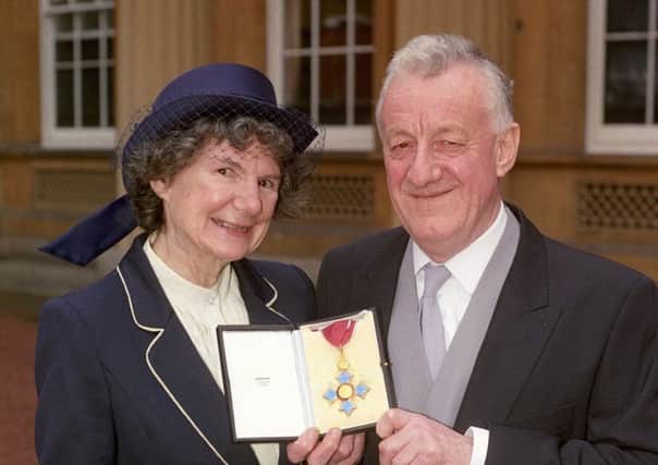 Chris Moncrieff and his wife Maggie displaying his CBE outside Buckingham Palace in 1990.  (Picture: PA Wire)
