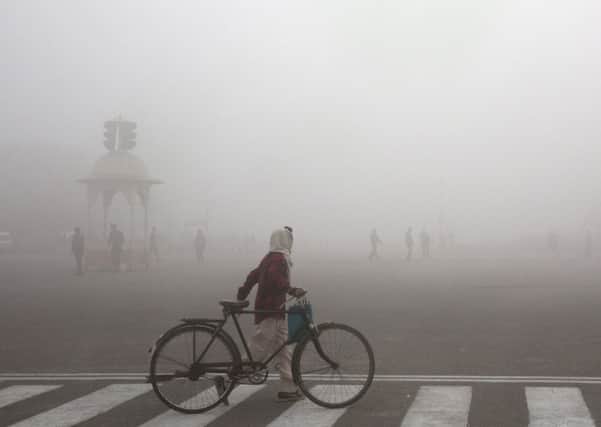 A cyclist amid the morning smog in New Delhi (Picture: Manish Swarup/AP)