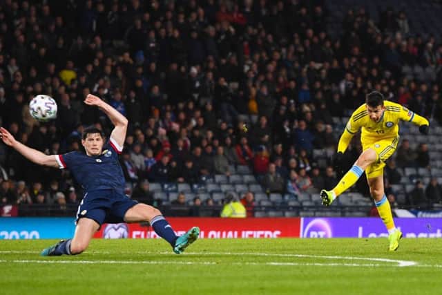 Defender Scott McKenna can get a challenge in as Baktiyor Zainutdinov gives Kazakhstan the lead at Hampden (Photo by Craig Williamson / SNS Group)