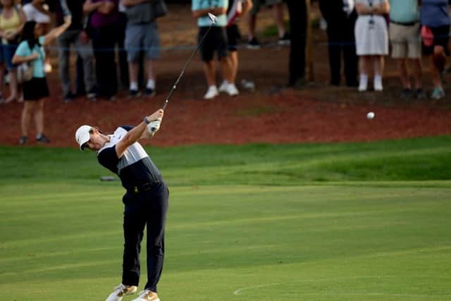 Rory McIlroy plays a majestic second shot to within five feet of the par-5 18th hole on the way to an eagle finish in Dubai. Picture: Ross Kinnaird/Getty Images