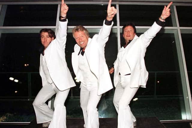 See, older man can still dance like Travolta as demonstrated by, from left, Jonathan Ross, Richard Branson and Roland Rivron